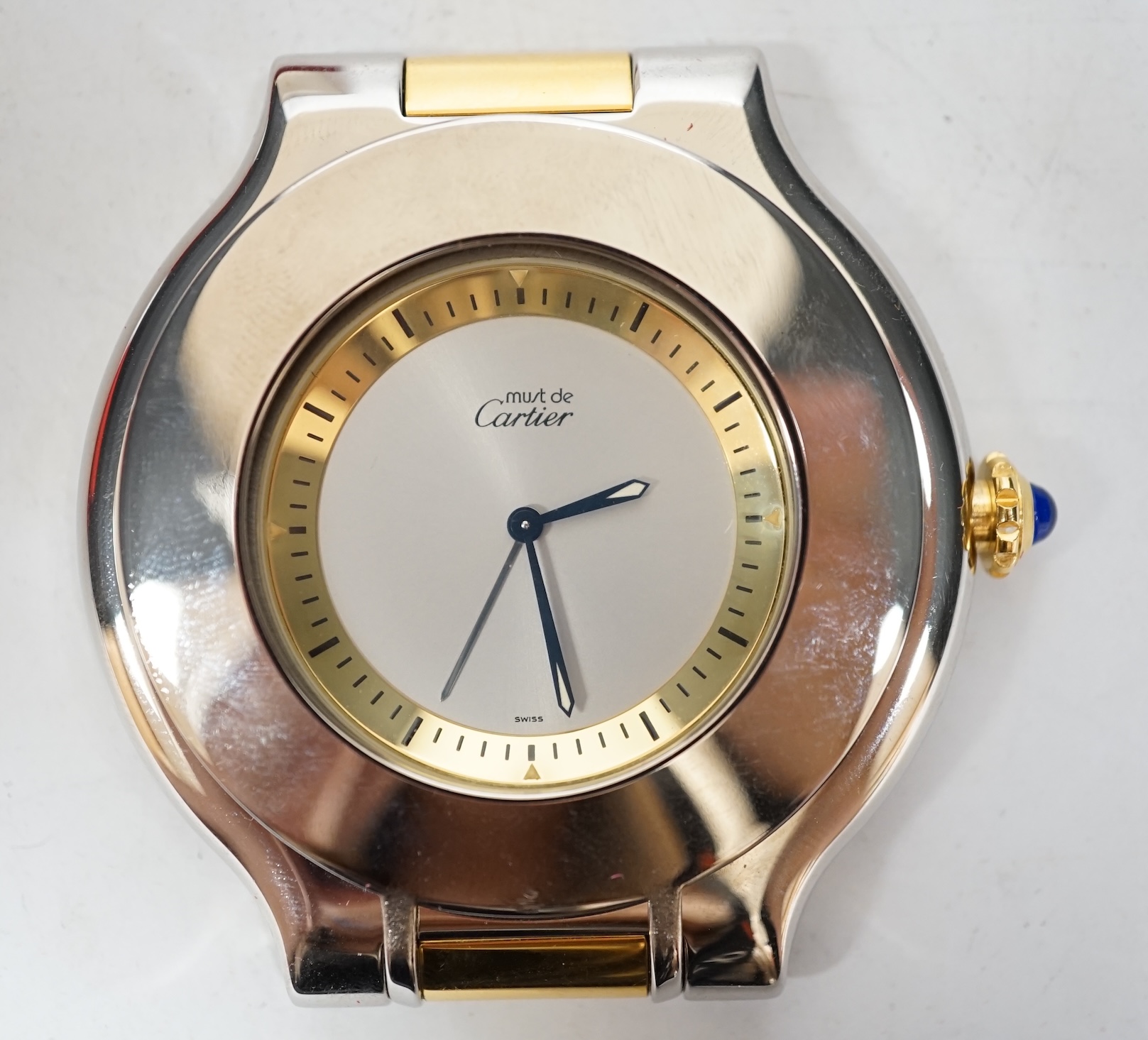 A Must de Cartier travelling alarm clock with pouch and case, 6cm wide. Condition - good, not tested